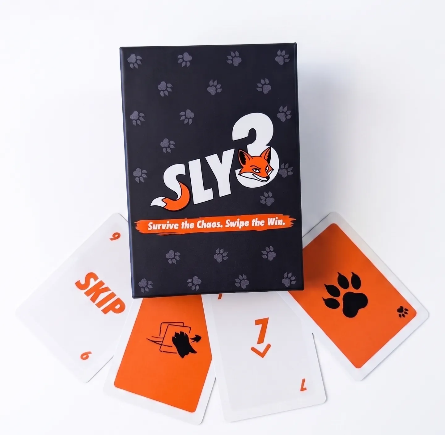 The Sly3 box standing behind a fan of its four special cards on a white surface